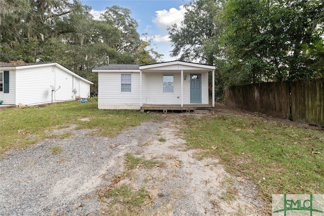 rear view of property featuring a yard