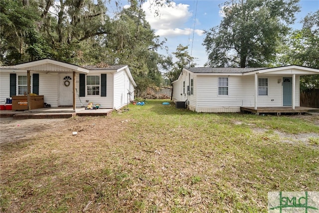 exterior space featuring a front lawn and central AC