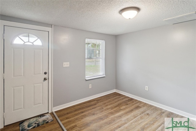 foyer entrance with a textured ceiling and hardwood / wood-style floors