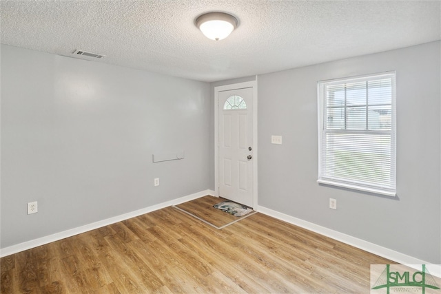 entrance foyer featuring a textured ceiling and hardwood / wood-style floors