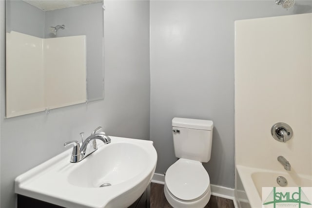 full bathroom with shower / tub combination, hardwood / wood-style floors, toilet, and sink