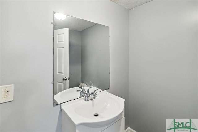 bathroom featuring a textured ceiling and vanity