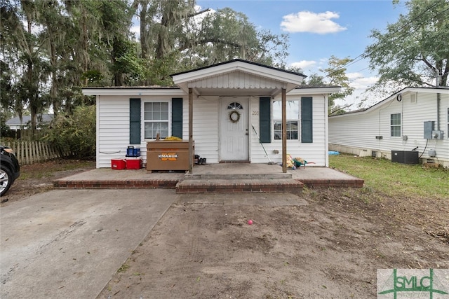 bungalow-style house with central air condition unit