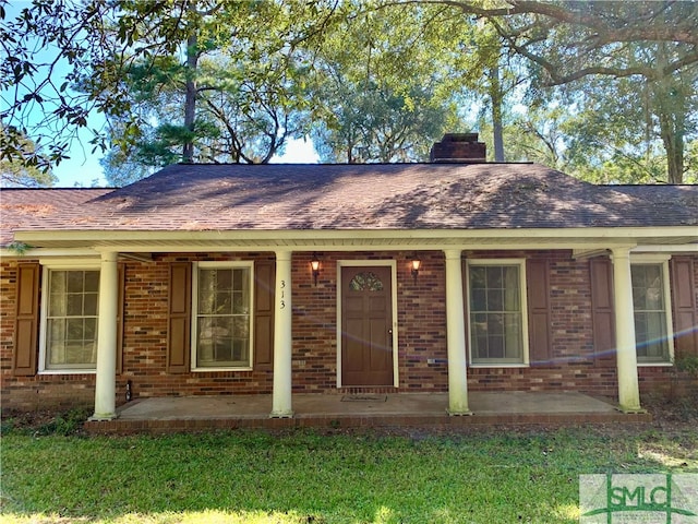 exterior space featuring a yard and covered porch