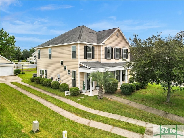 view of front facade with a garage, a porch, and a front lawn