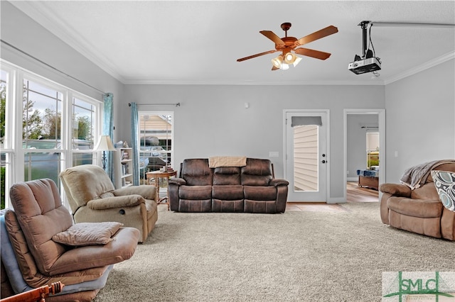 living room featuring light carpet, crown molding, and ceiling fan