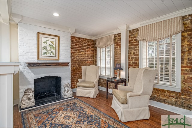 sitting room with a fireplace, hardwood / wood-style flooring, and a wealth of natural light