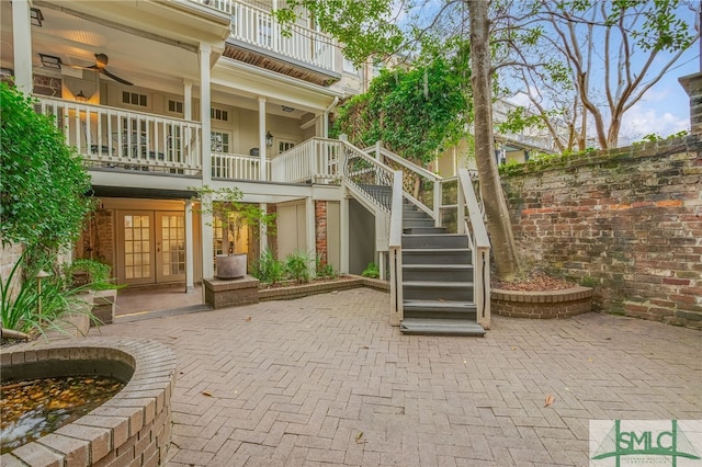 view of patio with french doors and a balcony