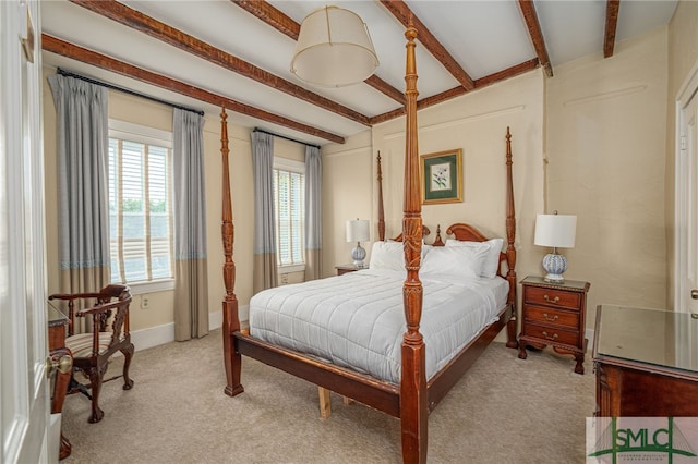 carpeted bedroom with beam ceiling