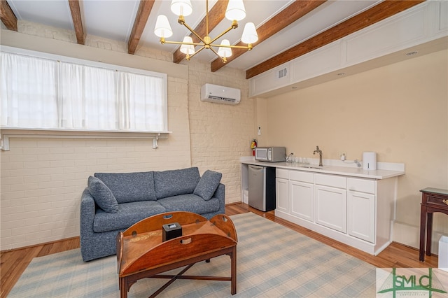 living room featuring beamed ceiling, a wall mounted AC, brick wall, a chandelier, and light wood-type flooring