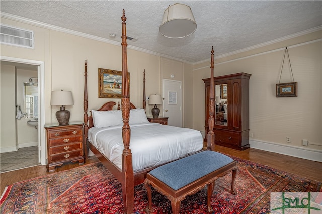 bedroom with ornamental molding, a textured ceiling, and dark hardwood / wood-style flooring