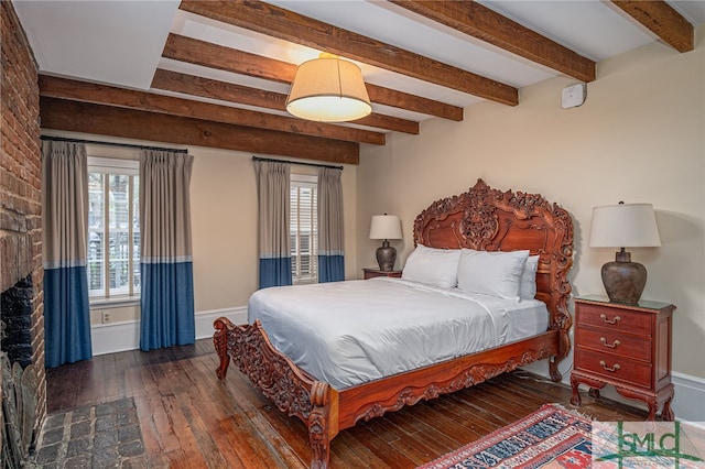 bedroom with beam ceiling and dark hardwood / wood-style floors