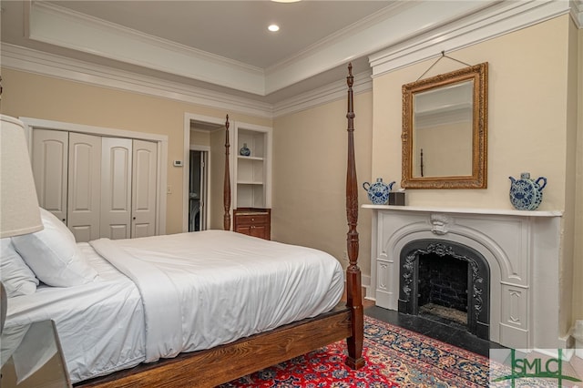 bedroom with crown molding and a closet