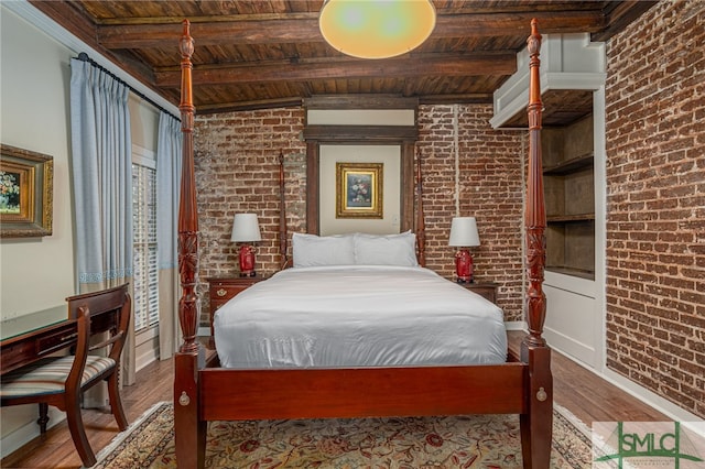 bedroom featuring brick wall, beamed ceiling, hardwood / wood-style flooring, and wooden ceiling