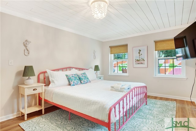 bedroom featuring wooden ceiling and hardwood / wood-style flooring