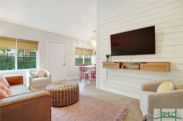 tiled living room featuring wood walls and a healthy amount of sunlight