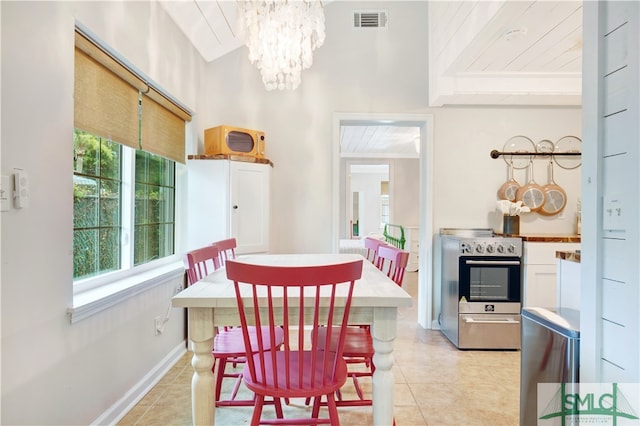 dining room with a chandelier, light tile patterned floors, and wood ceiling