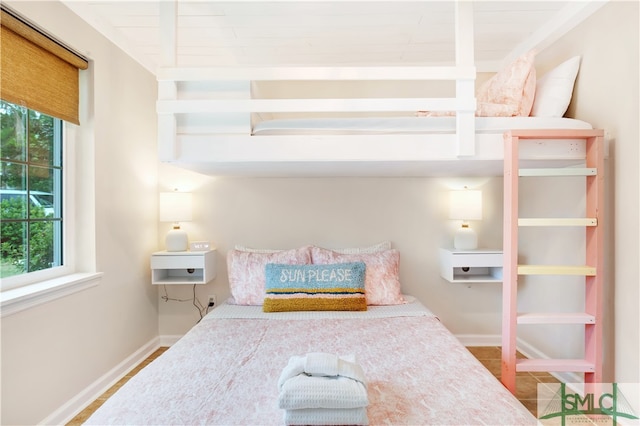 bedroom with beamed ceiling and tile patterned floors