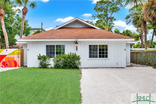 rear view of property featuring a yard