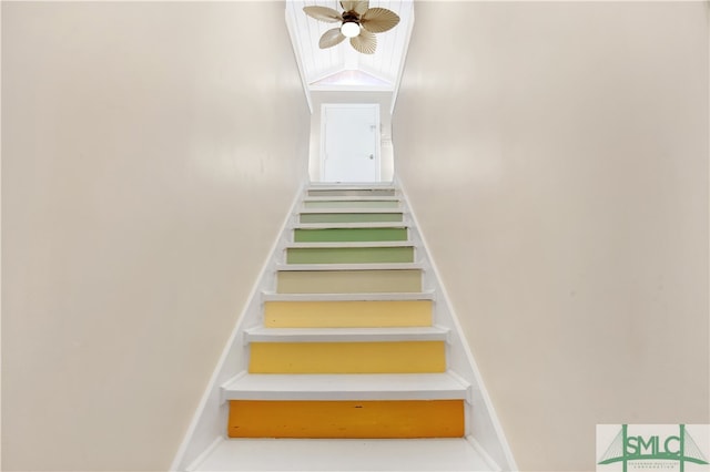 staircase with vaulted ceiling and ceiling fan