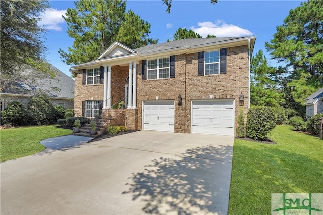 view of front of property with a garage and a front lawn