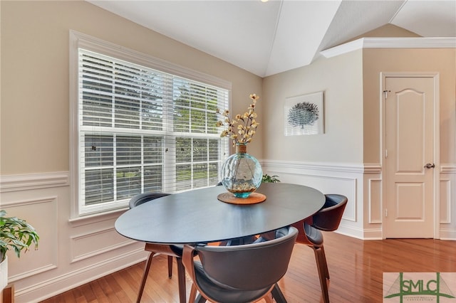 dining room featuring hardwood / wood-style floors and vaulted ceiling