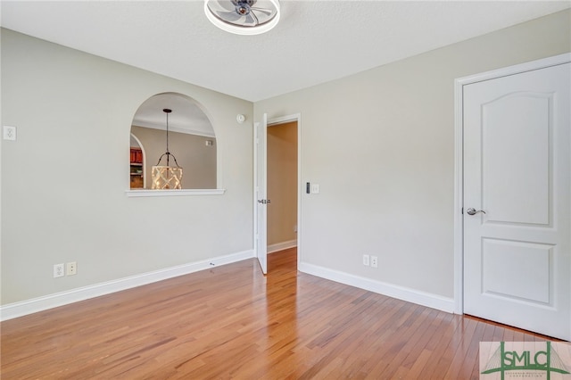 empty room featuring ceiling fan and hardwood / wood-style floors