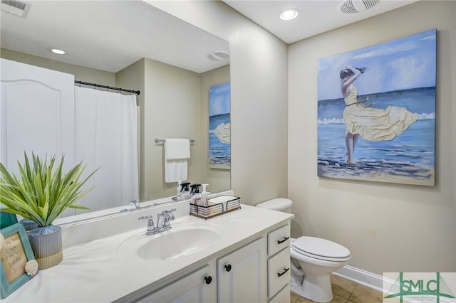 bathroom with vanity, tile patterned flooring, and toilet