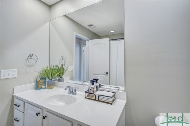 bathroom featuring vanity and toilet