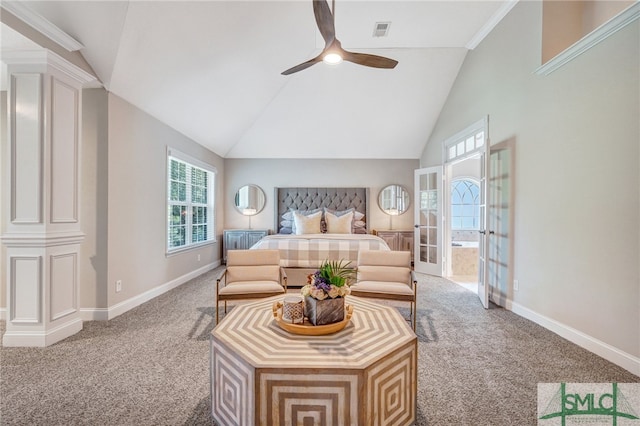 carpeted bedroom with high vaulted ceiling, decorative columns, and ceiling fan