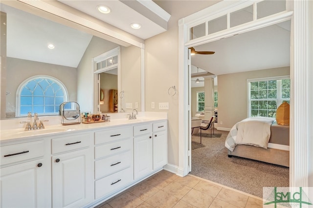 bathroom featuring tile patterned flooring, lofted ceiling, ceiling fan, and vanity