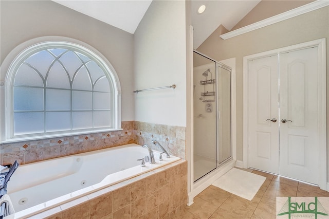 bathroom with shower with separate bathtub, lofted ceiling, and tile patterned floors