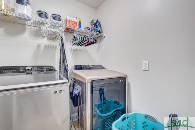 clothes washing area featuring washer and clothes dryer