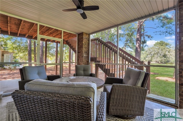 sunroom / solarium featuring a wealth of natural light and ceiling fan