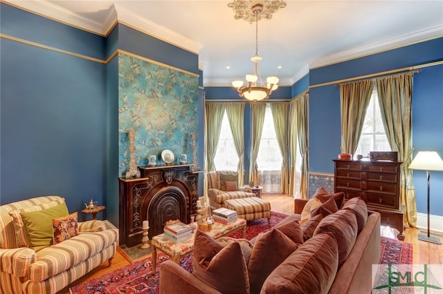 living room featuring ornamental molding, a chandelier, and hardwood / wood-style flooring