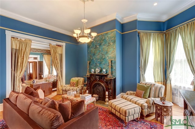 living area featuring ornamental molding, hardwood / wood-style flooring, and a healthy amount of sunlight