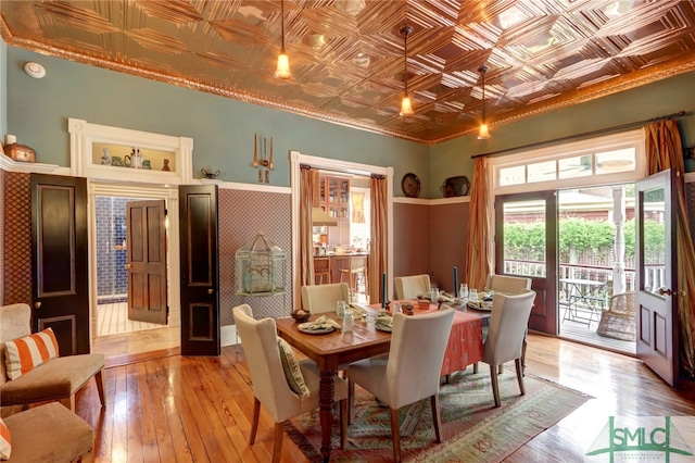 dining space featuring ornamental molding and light hardwood / wood-style flooring