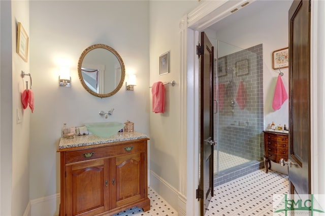 bathroom with vanity and tiled shower