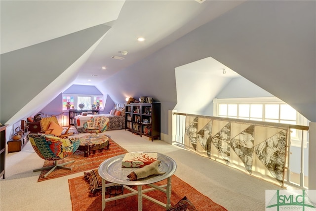 interior space with vaulted ceiling and light colored carpet