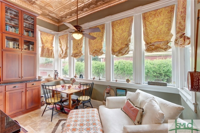 sunroom featuring ceiling fan