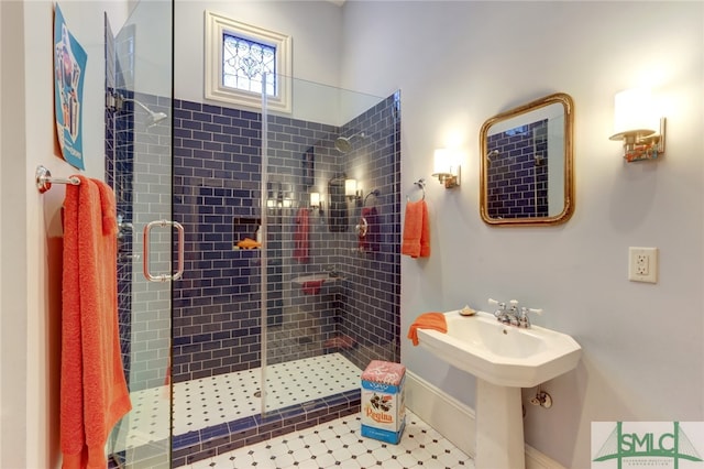 bathroom with tile patterned flooring and a shower with door