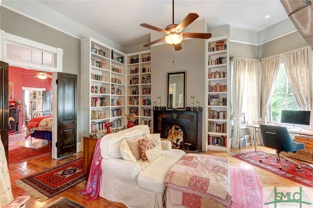 interior space featuring light hardwood / wood-style floors, a fireplace, and ceiling fan