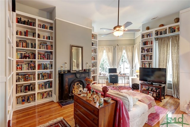 living room featuring light hardwood / wood-style floors, a fireplace, and ceiling fan