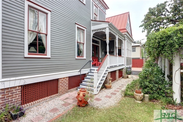 view of side of home with a porch