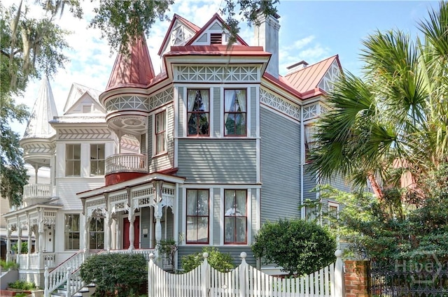 14 W Duffy St, Savannah, GA 31401 - victorian-style house featuring a fenced front yard, metal roof, and a standing seam roof
