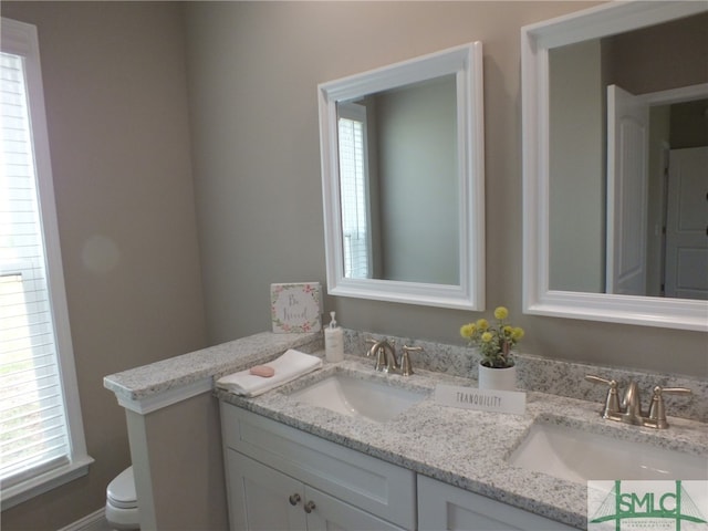 bathroom featuring vanity and toilet