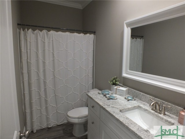 bathroom featuring toilet, wood-type flooring, crown molding, a shower with shower curtain, and vanity