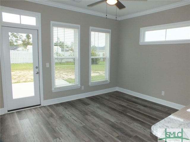 interior space with ceiling fan, dark hardwood / wood-style floors, ornamental molding, and a healthy amount of sunlight