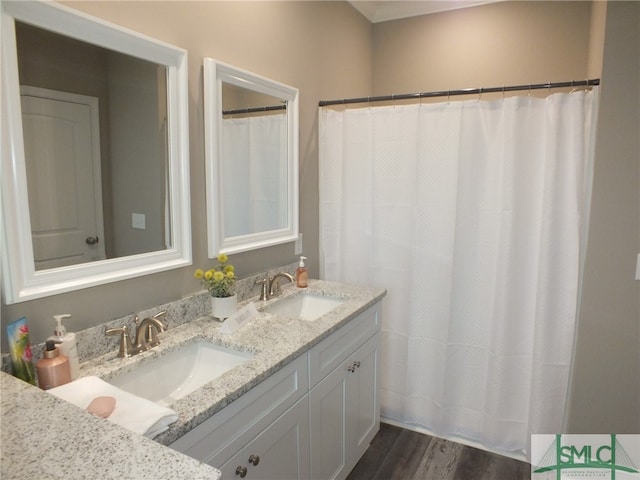 bathroom with hardwood / wood-style floors, vanity, and curtained shower