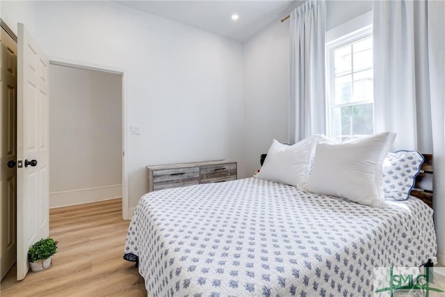 bedroom with light wood finished floors, baseboards, and recessed lighting